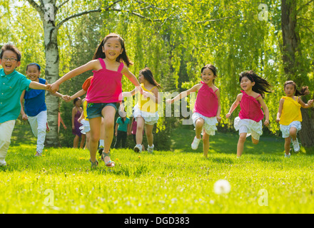 Children running on grass Stock Photo