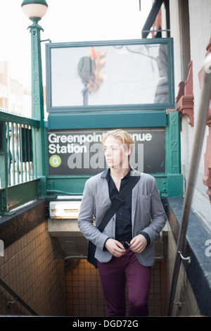 Young man emerging from subway station Brooklyn, New York City, USA Stock Photo