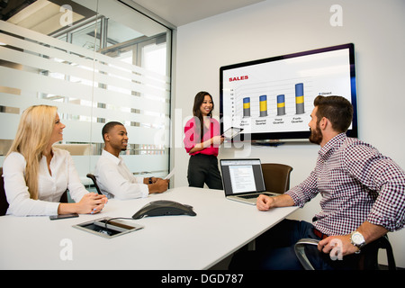 Young business colleagues looking at digital table in meeting in conference room Stock Photo
