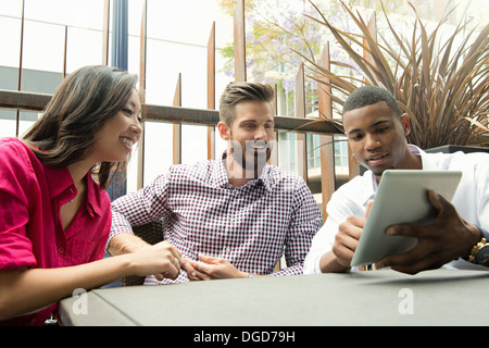 Young business colleagues looking at digital tablet in meeting Stock Photo