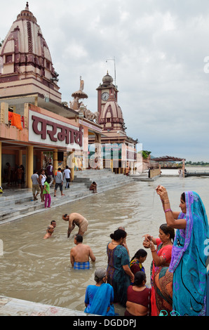 Morning prayers and bathers in the Ganges River, Rishikesh, India Stock Photo