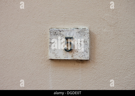 three dimensional house number five. Black lettering on a white background. Stock Photo