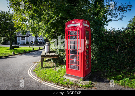 A traditional red telephone box on the village square in Crantock Village in Newquay Cornwall. Stock Photo