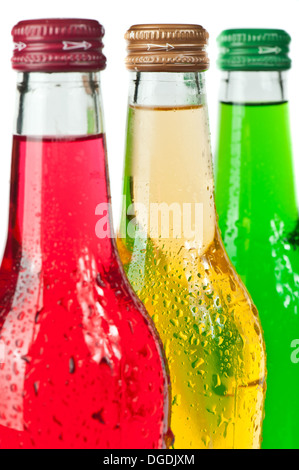 Assortment of cold bottles of pop or coolers on white background Stock Photo