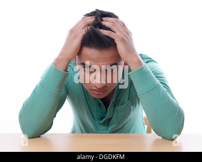 young man with head in hands Stock Photo