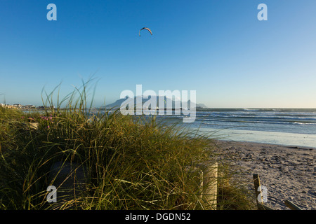 Kite boarders get in a last session before the sun sets on Cape Town Stock Photo