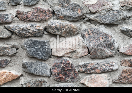 Old gray rough stone wall background photo texture Stock Photo