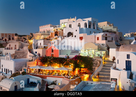 Beautiful Oía with its restaurants in the evening. Santorini, Greece. Stock Photo