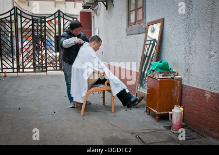 barber on street in Shanghai, China Stock Photo