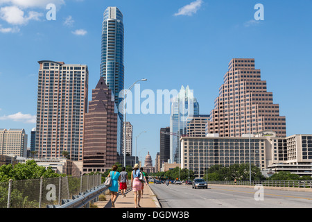 Traffic and tourists cross S Congress Avenue bridge with Austin skyline in background Texas USA Stock Photo