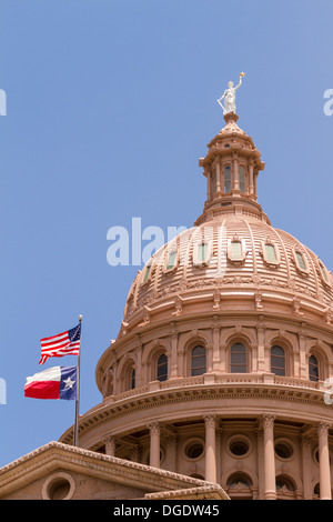 US and Texas flags flying over Texas State Capitol building Austin USA