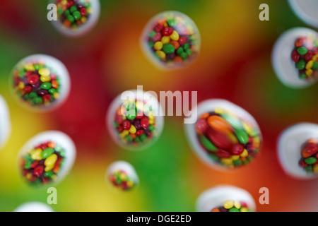 skittles sweets candies reflected in water droplets - colourful abstract Stock Photo