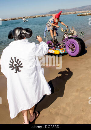 Ventura, CA, USA. 19th Oct, 2013. A race judge photographs a competitor as he emerges from the water challenge onto the sand of Ventura Harbor during the 16th Annual Kinetic Sculpture Race. The water, sand, mud and road race challenge event is a fundraiser for the Turning Point Foundation, a non-profit which aids people with mental illness in Ventura County. Credit:  Brian Cahn/ZUMAPRESS.com/Alamy Live News Stock Photo