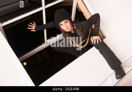 Masked Woman Sneaking Lurking Around Looking For Something to Steal Stock Photo