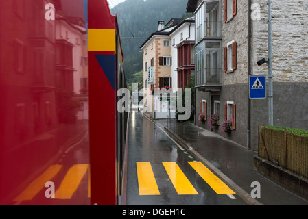 Bernina Express train passing through Poschiavo, Switzerland, Stock Photo