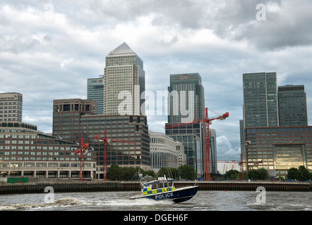 UK London Metropolitan Police Boat Sir Robert Peel II patrols the River Thames alongside the business area of Canary Wharf Stock Photo