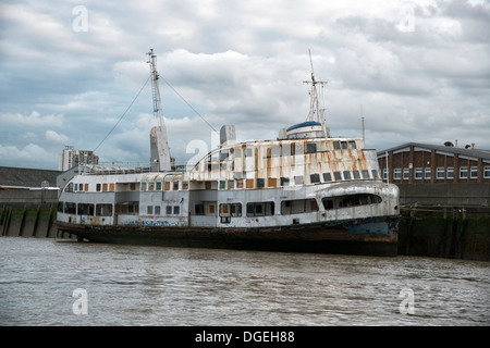 The rusting hulk of the old Mersey Ferry The Royal Iris tied up on the banks of the River Thames in Woolwich, East London. Stock Photo