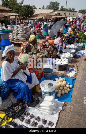 Weekly Market at Fass Njaga Choi, North Bank Region, The Gambia. Women Selling Soap; Cooking and Washing Utensils in Background. Stock Photo