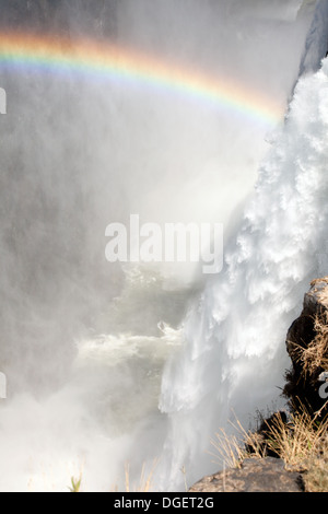 Victoria Falls rainbow, main cataract and rainbow looking to the bottom of the falls from Livingstone Island, Zambia side, Africa Stock Photo