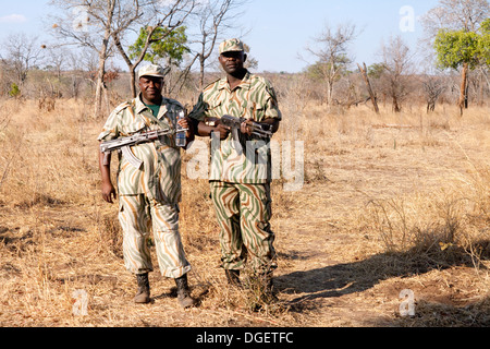 Wildlife Conservation Africa - Two Zambian wildlife rangers guard against poaching of white rhinos in Mosi oa Tunya National Park, Zambia Africa Stock Photo