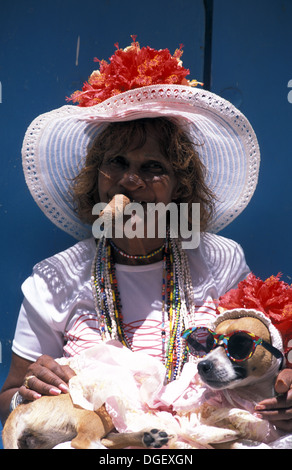 Old lady posing with a fancy dressed dog smoking a Cuban cigar. Old Havana Stock Photo