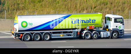 BP fuel delivery tanker lorry driving along motorway and displaying Hazchem Hazardous Chemicals Dangerous Goods sign Stock Photo