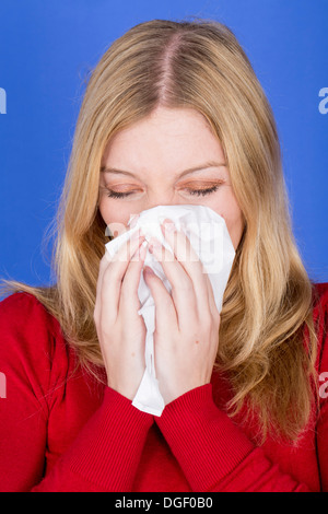 Model Released. Young Woman Blowing Nose Stock Photo