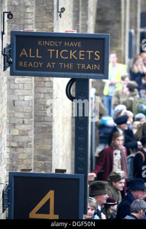 London, UK. 20th Oct, 2013. 'The Imitation Game' - a new film starring Benedict Cumberbatch, Keira Knightley, Henry Cavill and Mark Strong - is filmed at Kings Cross Raliway Sation in London with steam trains next to current day passenger trains. Scenes with children dressed in wartime clothes and others dressed as soldiers were seen as regular passengers arrived at the busy London concourse on Sunday October 20th 2013  Photo by Keith Mayhew/Alamy Live News Stock Photo