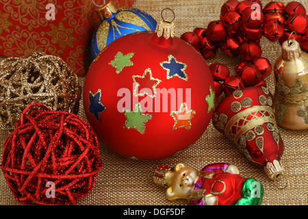 Festive winter tree decorations with large silky poinsettia flowers,  glitter tree balls and golden mesh ribbons, seasonal Christmas ornamentas  Stock Photo - Alamy
