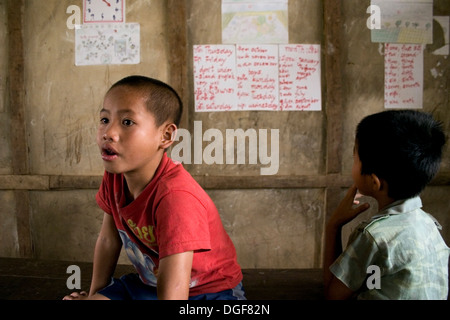 Two boys are sitting in their sparse classroom at the Ban Bumlao primary school in Ban Bumlao, Luang Prabang Province, Laos. Stock Photo