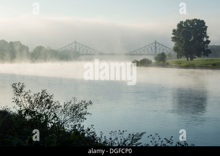 Morning fog on the Elbe river, Loschwitz Bridge or Blue Wonder bridge at the back, Dresden, Saxony, Germany Stock Photo