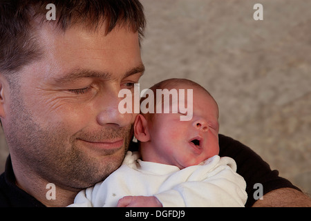 Proud father holding his newborn baby boy in his arms, Germany Stock Photo