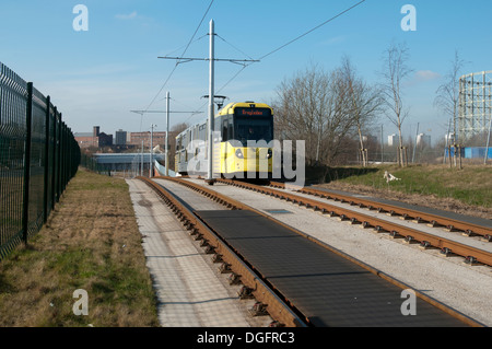 Metrolink tram near the Etihad Campus stop, on the East Manchester Line, Eastlands, Manchester, England, UK Stock Photo