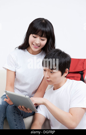 a boy and a girl with a tablet Stock Photo