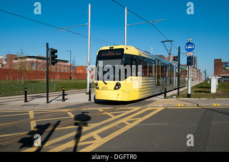 A Metrolink tram crossing Sheffield Street, near Piccadilly Station, Manchester, England, UK Stock Photo