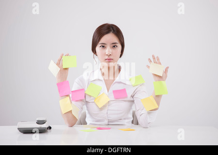 a business woman full of post it notes Stock Photo