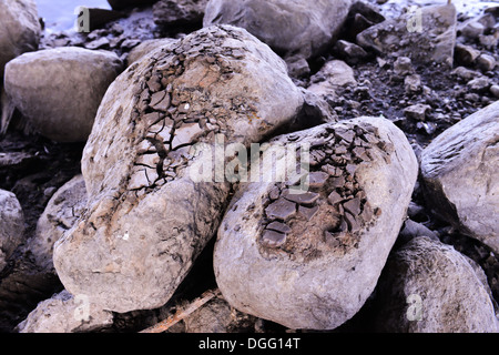 Textured broken clay on two rocks Stock Photo