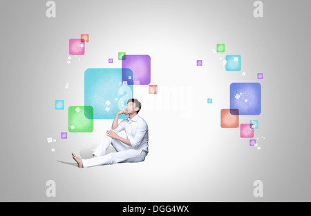 a man sitting on the floor Stock Photo