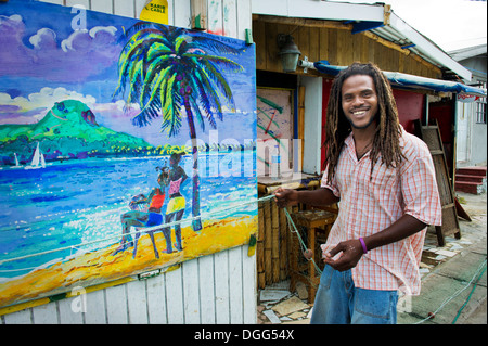 Happy, West Indian Artist with his painting of St. Lucia in the Caribbean Stock Photo