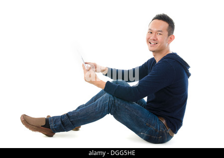 Young Asian student using pad PC isolated on white background. Stock Photo