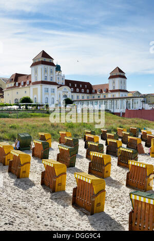 Roofed wicker beach chairs on the beach in front of the Kurhaus spa building, Binz, Mecklenburg-Western Pomerania, Germany Stock Photo