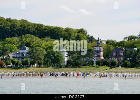 Beach and roofed wicker beach chairs in front of resort or Baeder architecture, Binz, Mecklenburg-Western Pomerania, Germany Stock Photo