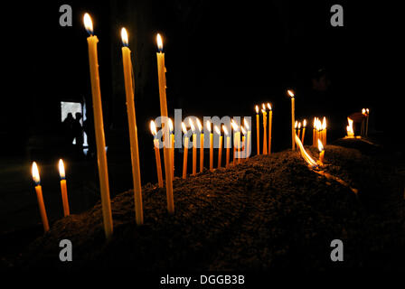 Candles burning in the Armenian orthodox church at Geghard monastery near Garni, UNESCO World Heritage Site, Kotayk region Stock Photo