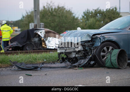 After a head-on collision a Peugeot car landed on the light railway tracks and caught fire, the driver burnt inside the wreckage Stock Photo