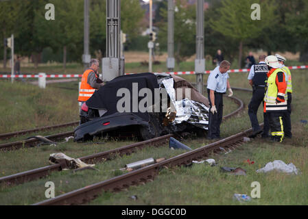 After a head-on collision a Peugeot car landed on the light railway tracks and caught fire, the driver burnt inside the wreckage Stock Photo