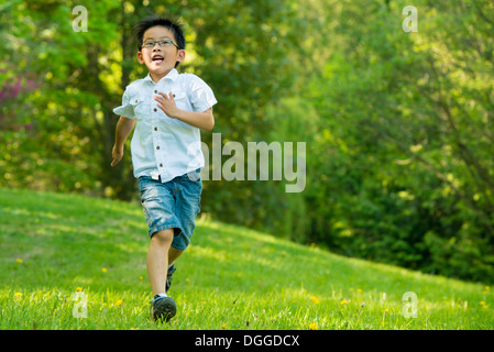 Boy running on grass Stock Photo