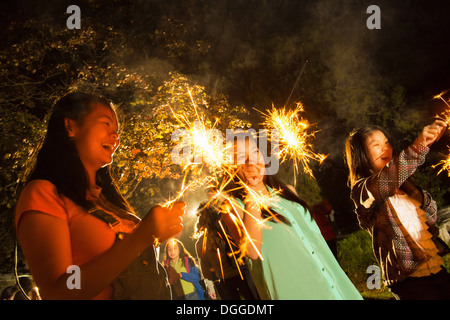 Girls with sparklers at night Stock Photo