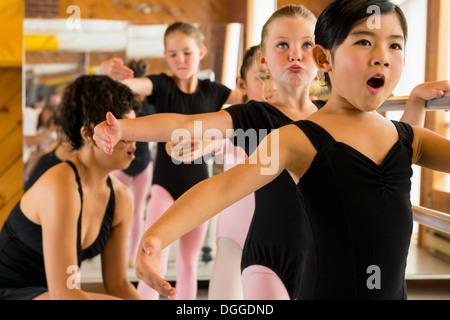 Ballerinas practising at the barre in ballet school Stock Photo