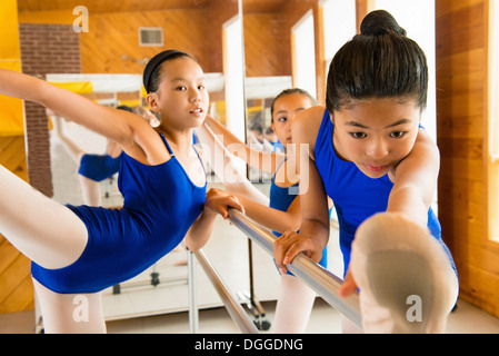 Ballerinas warming up at the barre in ballet school Stock Photo