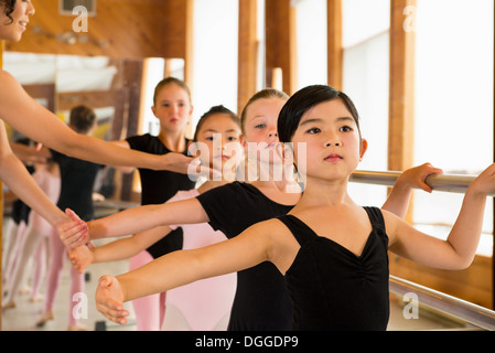 Ballerinas practising at the barre in ballet school Stock Photo